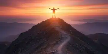 Unlock Your Potential: Master the Mindset Shifts for Goal Achievement Confident person on mountain peak at sunrise, symbolizing goal achievement